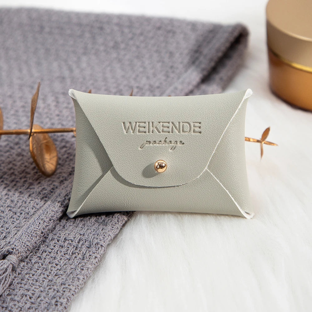 100 Stück Silberne Schmuckbeutel mit Logo – 10x7cm Lederbeutel mit Kordelzug | Für Ohrringe, Ringe, Halsketten, Münzen & Schlüsselanhänger Kaufschwan® Grau 10x7cm