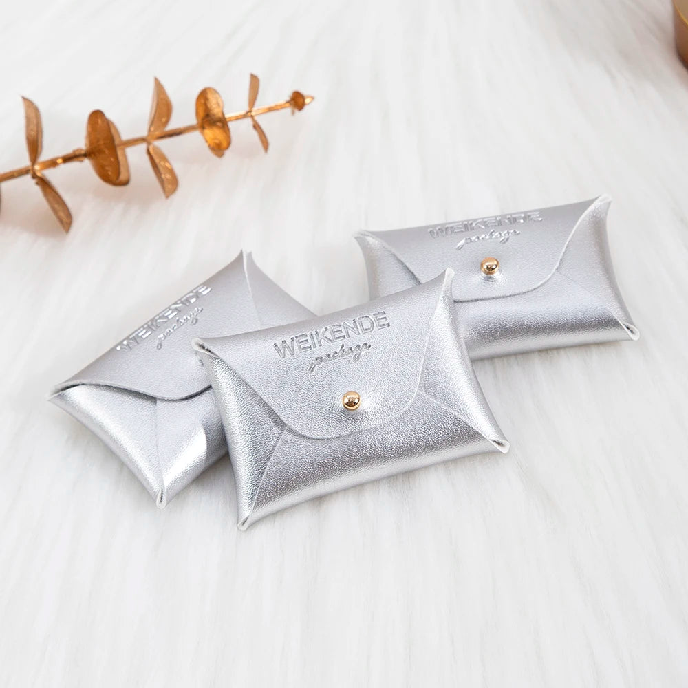 100 Stück Silberne Schmuckbeutel mit Logo – 10x7cm Lederbeutel mit Kordelzug | Für Ohrringe, Ringe, Halsketten, Münzen & Schlüsselanhänger Kaufschwan®