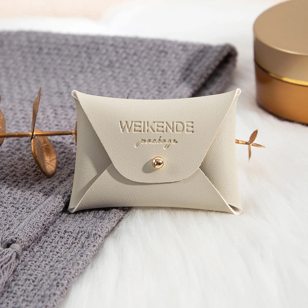 100 Stück Silberne Schmuckbeutel mit Logo – 10x7cm Lederbeutel mit Kordelzug | Für Ohrringe, Ringe, Halsketten, Münzen & Schlüsselanhänger Kaufschwan® Creme 7x5cm